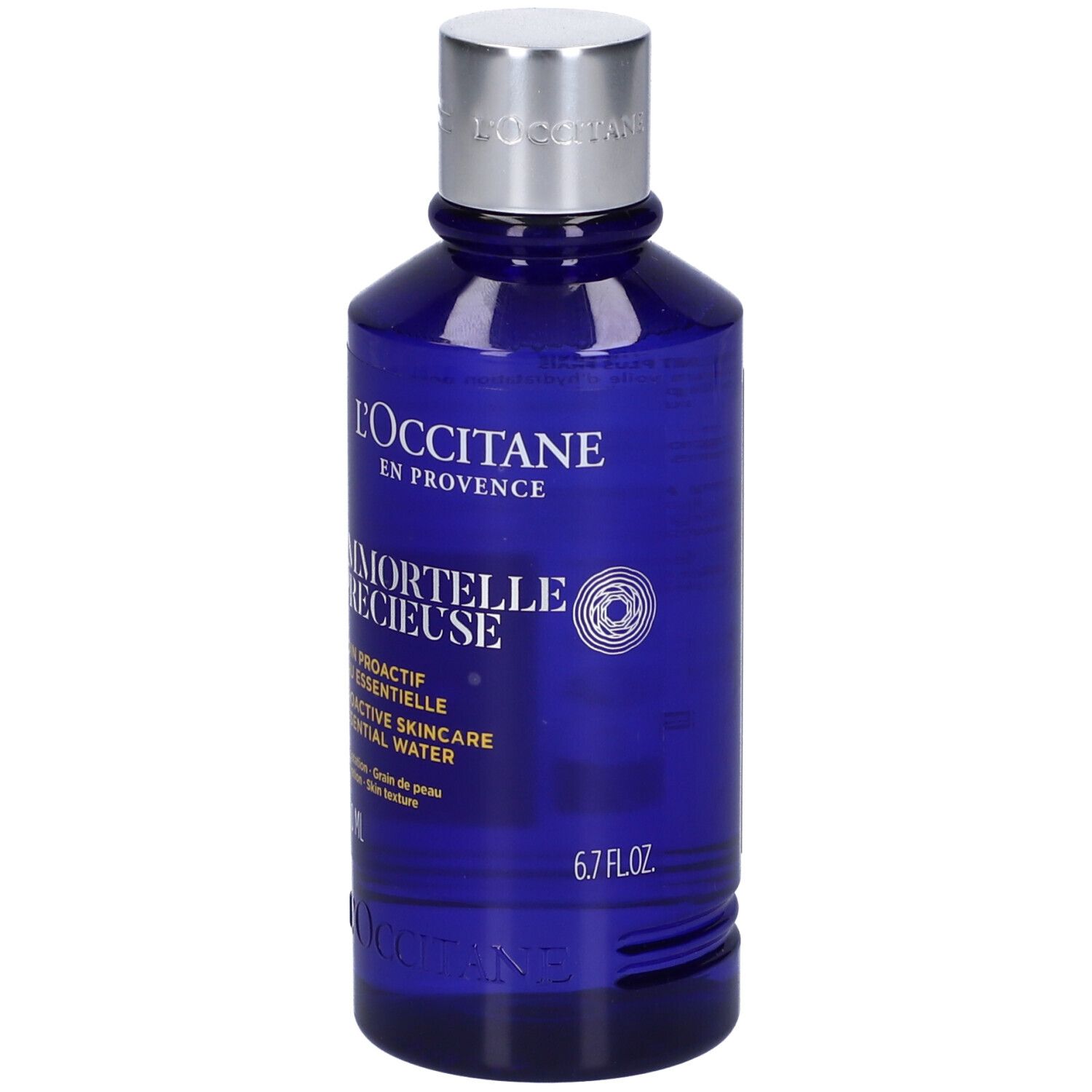 Blaue Flasche mit silbernem Deckel. Aufschrift: L'Occitane, Immortelle Précieuse, 6.7 FL.OZ.