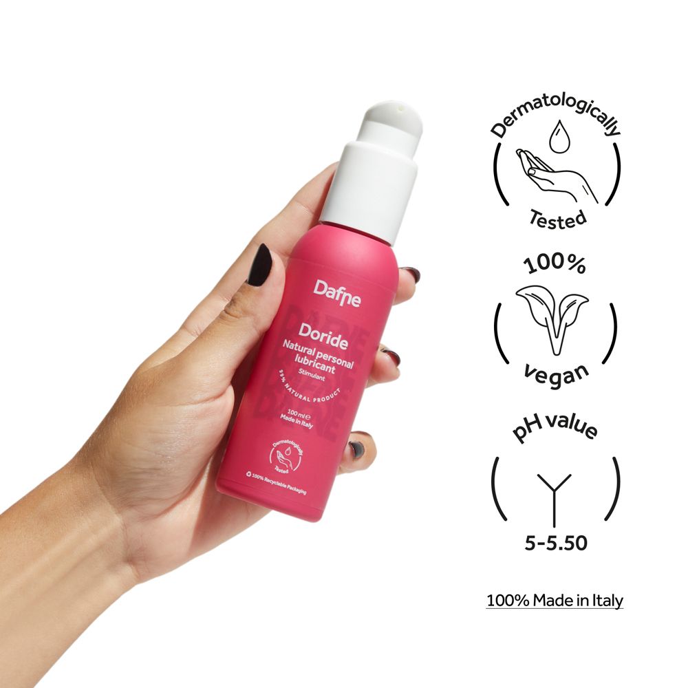 Mano che tiene flacone rosa con erogatore bianco. Scritta: Dafne Doride. Loghi: dermatologicamente testato, vegano, pH 5-5,50.