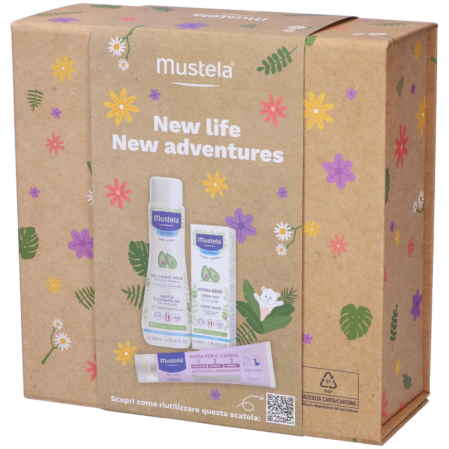 Confezione Mustela con prodotti. Scritta: New life New adventures. Contiene gel detergente, crema e pasta. Motivi floreali.