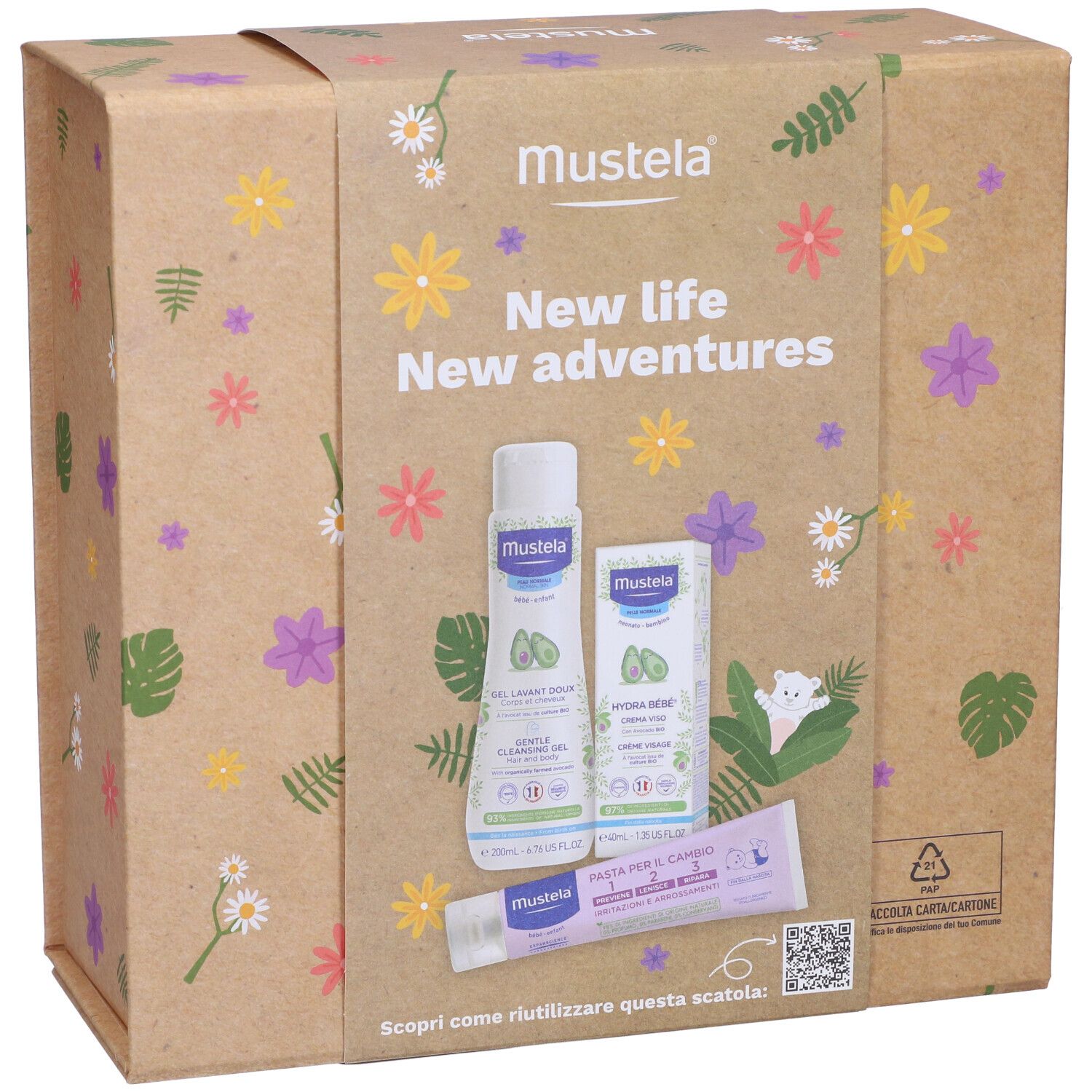 Confezione Mustela con prodotti. Scritta: New life New adventures. Contiene gel detergente, crema e pasta. Motivi floreali.