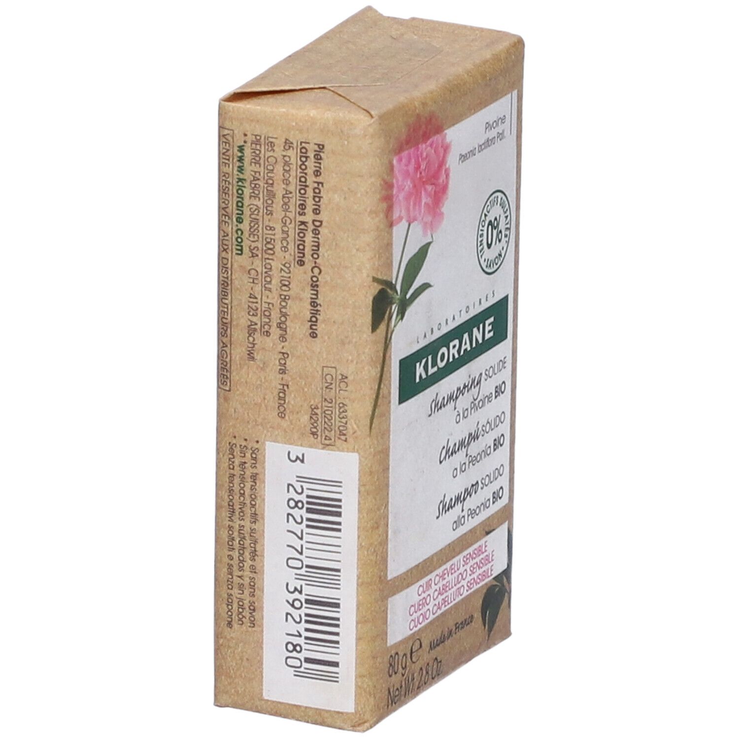 Klorane shampoo solido, confezione angolata. Scritto: Shampoo solido, 80g. Codice a barre e informazioni.
