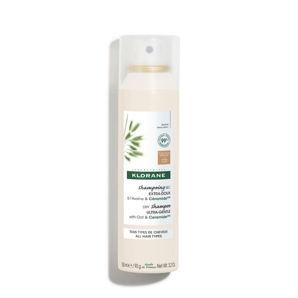 Spray Klorane bianco con erogatore. Logo e nome del prodotto. Contiene Avena & Ceramide. Per capelli scuri. Certificato.