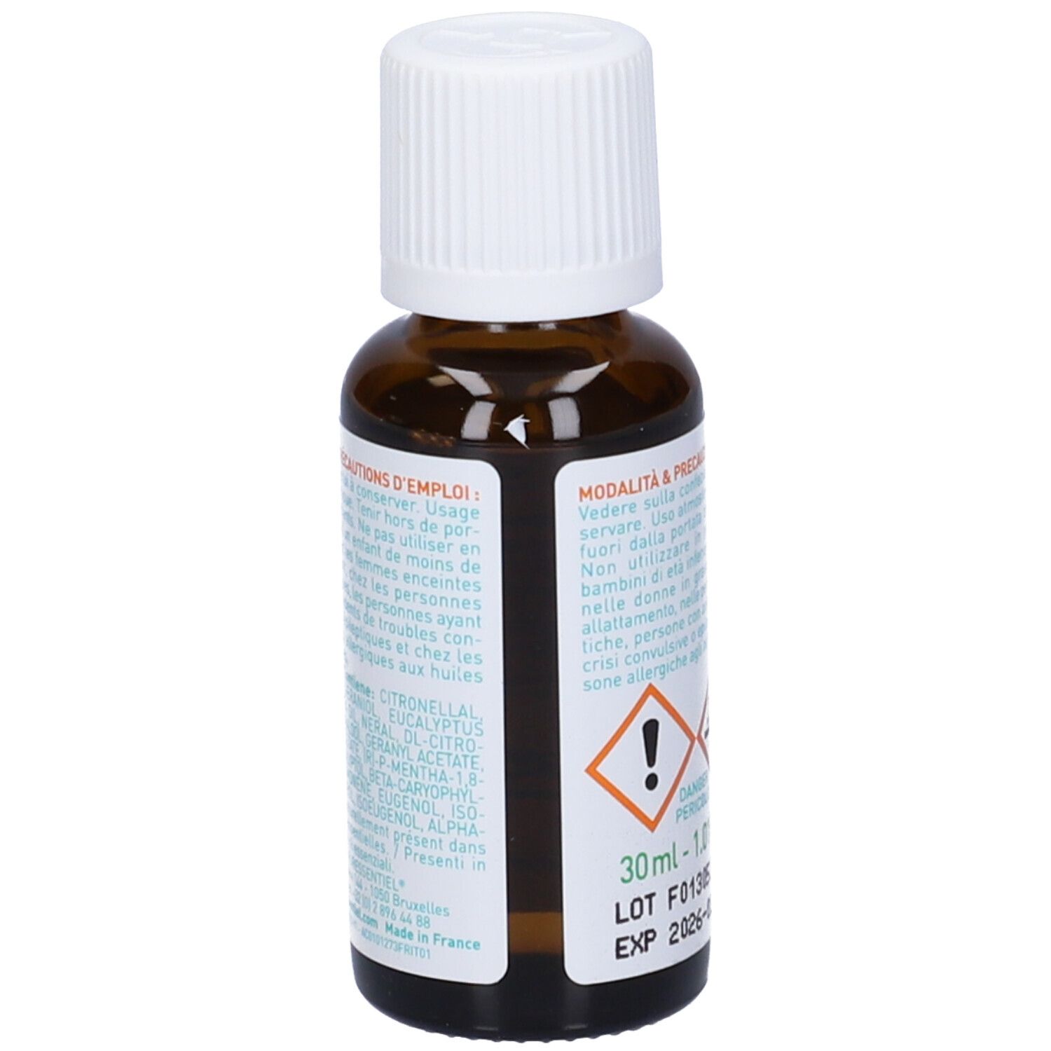 Flacone di vetro marrone con tappo bianco. Etichetta con testo in diverse lingue. Contiene ingredienti.