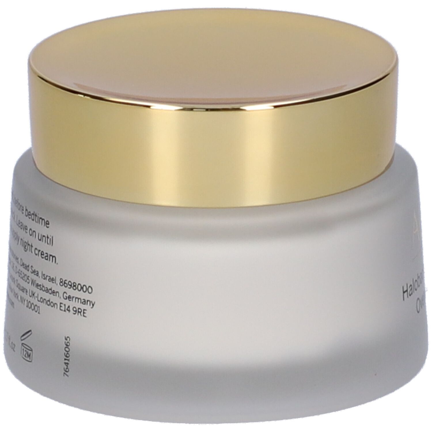 AHAVA Halobacteria Restoring Overnight Mask. Vista posteriore del vasetto crema con coperchio dorato. Testo sul vetro.