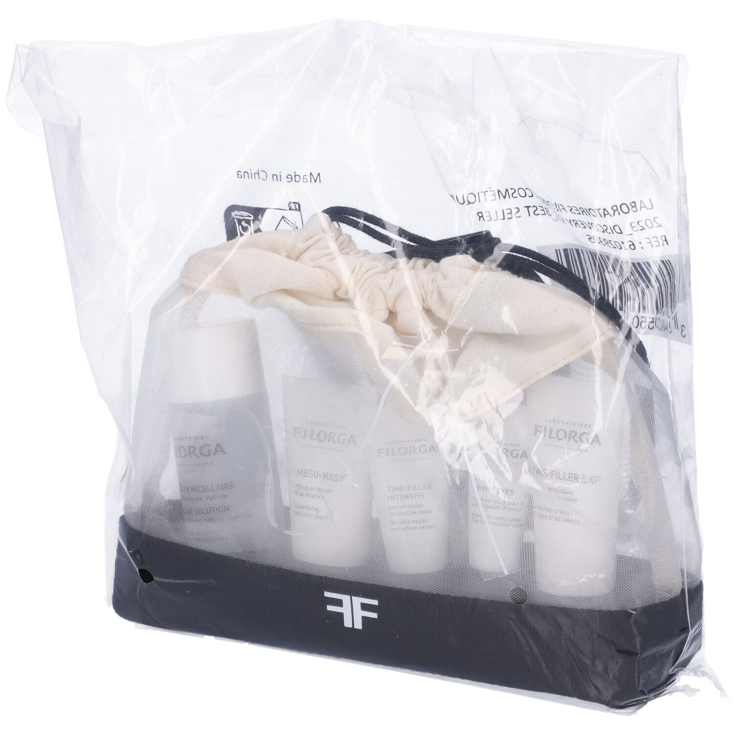 Filorga Discovery Kit in confezione di plastica. Prodotti in una borsa bianca e nera. Etichette visibili.