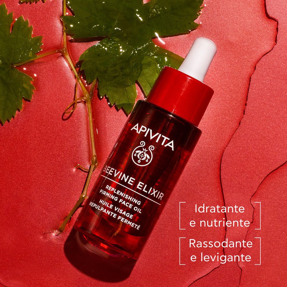 Flacone rosso scuro con contagocce bianco. Scritta: APIVITA, BEEVINE ELIXIR. Testo: Idratante e nutriente, Rassodante e levigante.