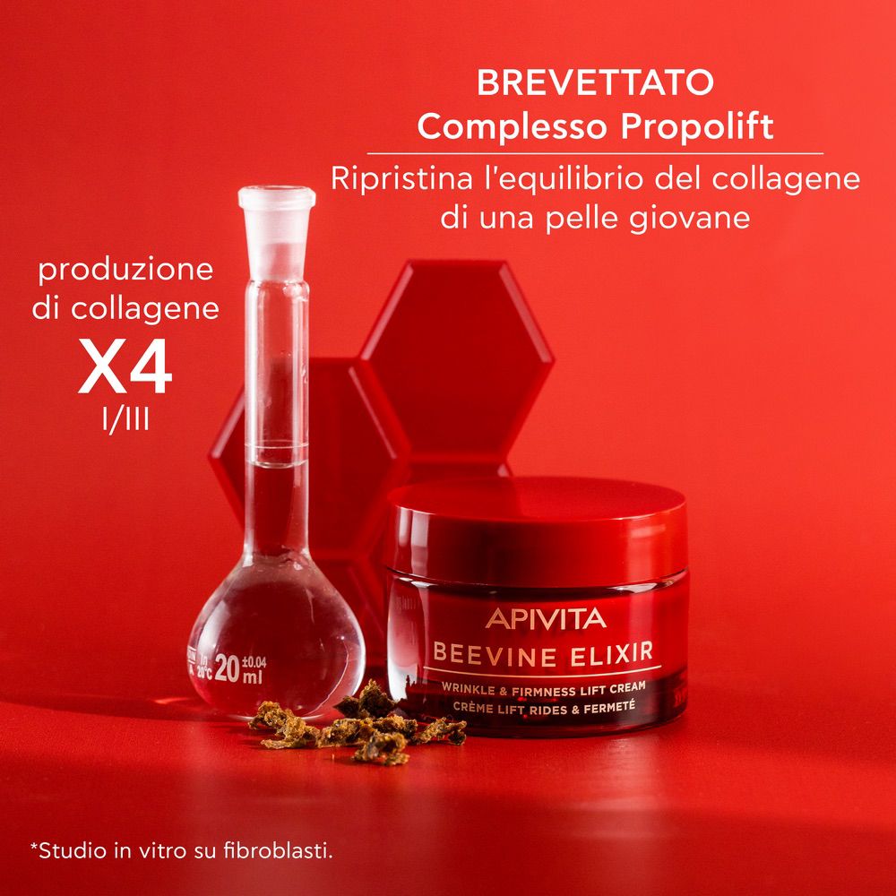 Vaso rosso APIVITA BEEVINE ELIXIR. Attrezzature di laboratorio e testo.