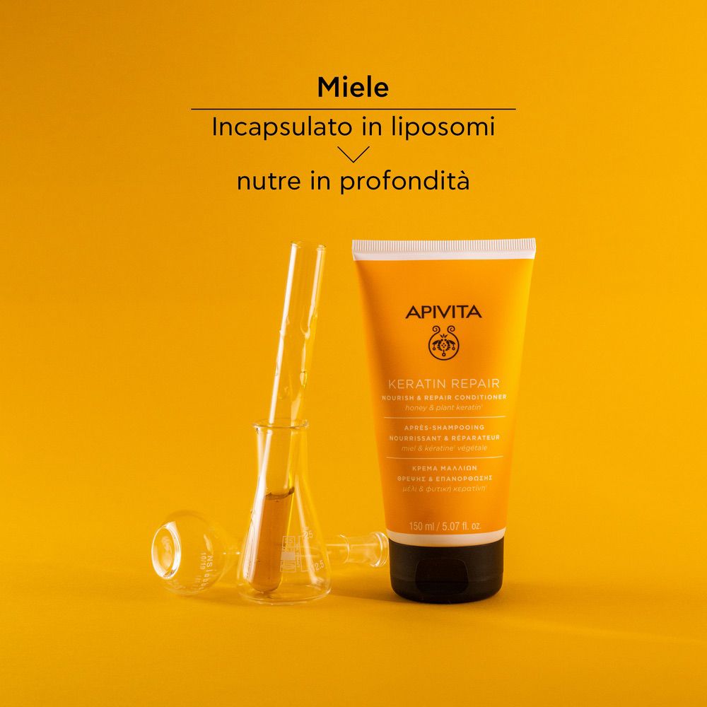 Tubo giallo, provette. Testo: Miele incapsulato in liposomi nutre in profondità. Scritta: APIVITA, Keratin Repair.