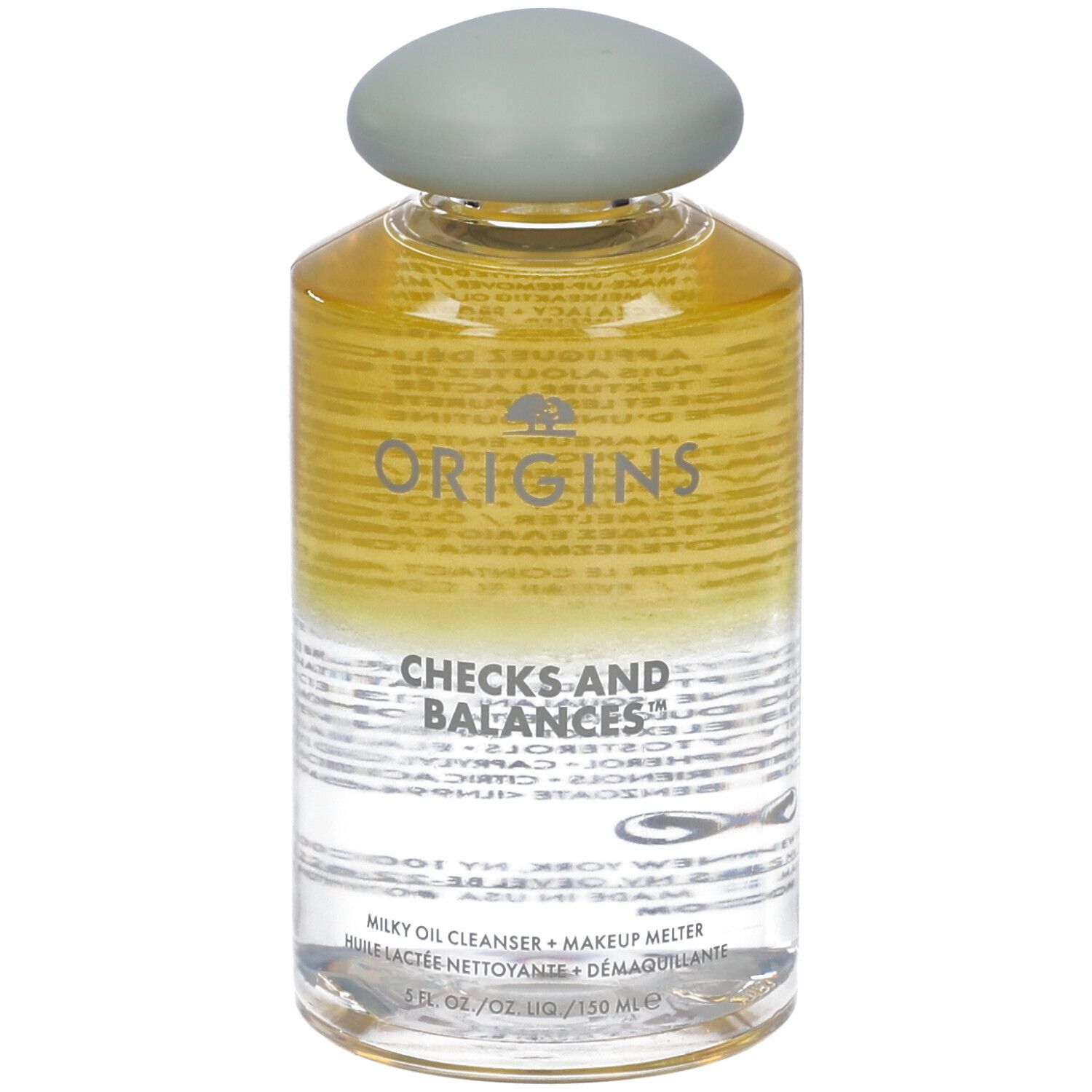 Flacone trasparente con tappo grigio. Scritta: Origins Checks and Balances. Detergente olio latte.