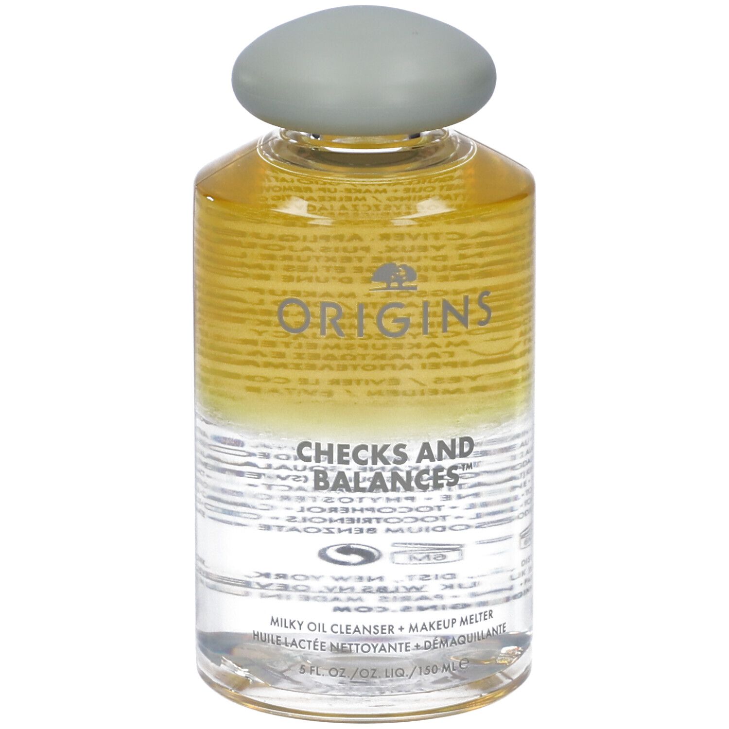 Flacone trasparente con tappo grigio. Scritta: Origins Checks and Balances. Detergente olio latte.