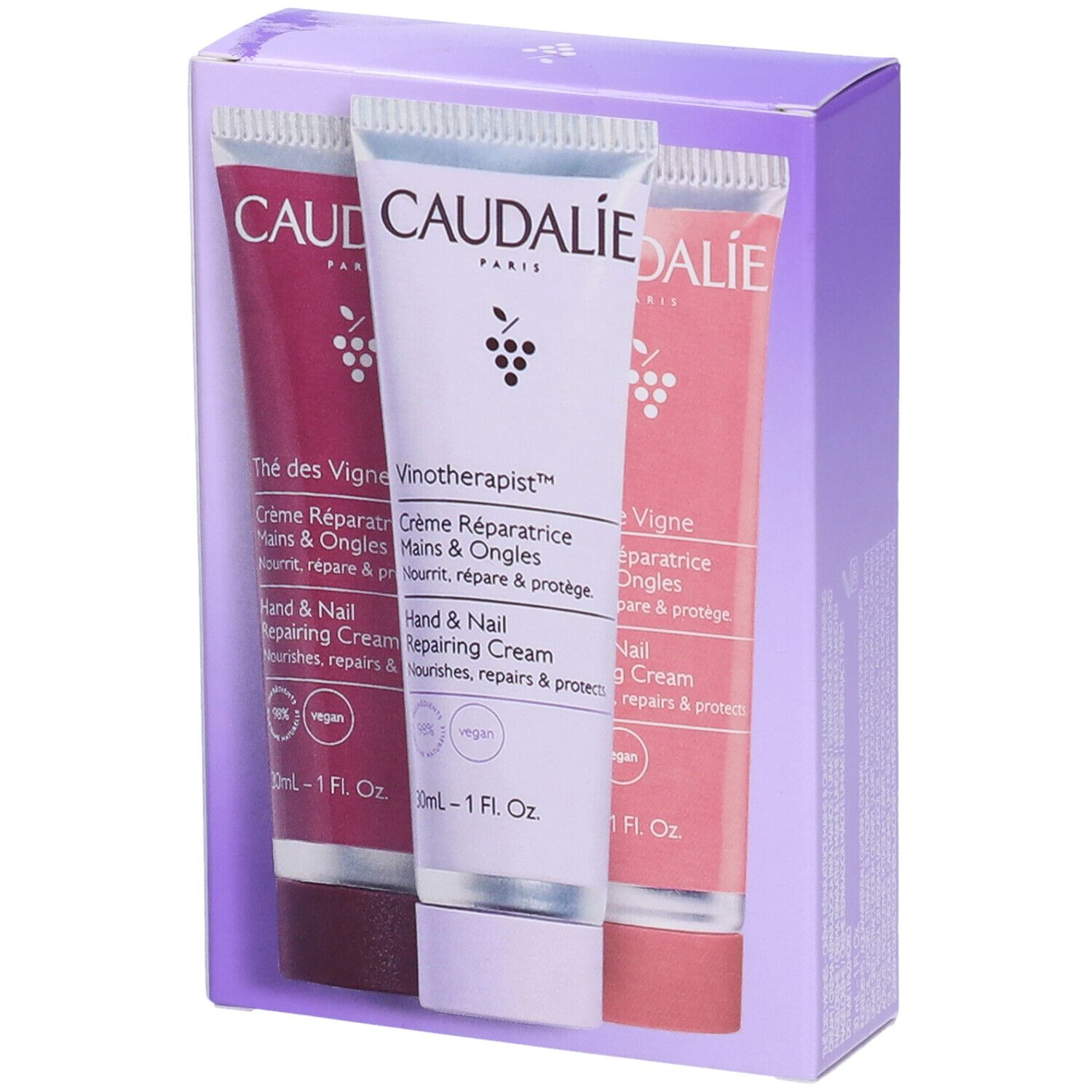 Tre tubetti di crema mani in confezione. Logo Caudalie, nomi prodotti, sigillo vegano, 1 fl. oz. per tubo.