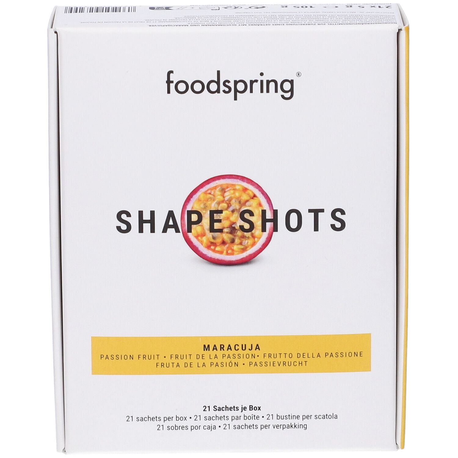 Scatola bianca con logo Foodspring e nome del prodotto. Immagine di frutto della passione. Testo: Shape Shots, Maracuja, 21 bustine per scatola.