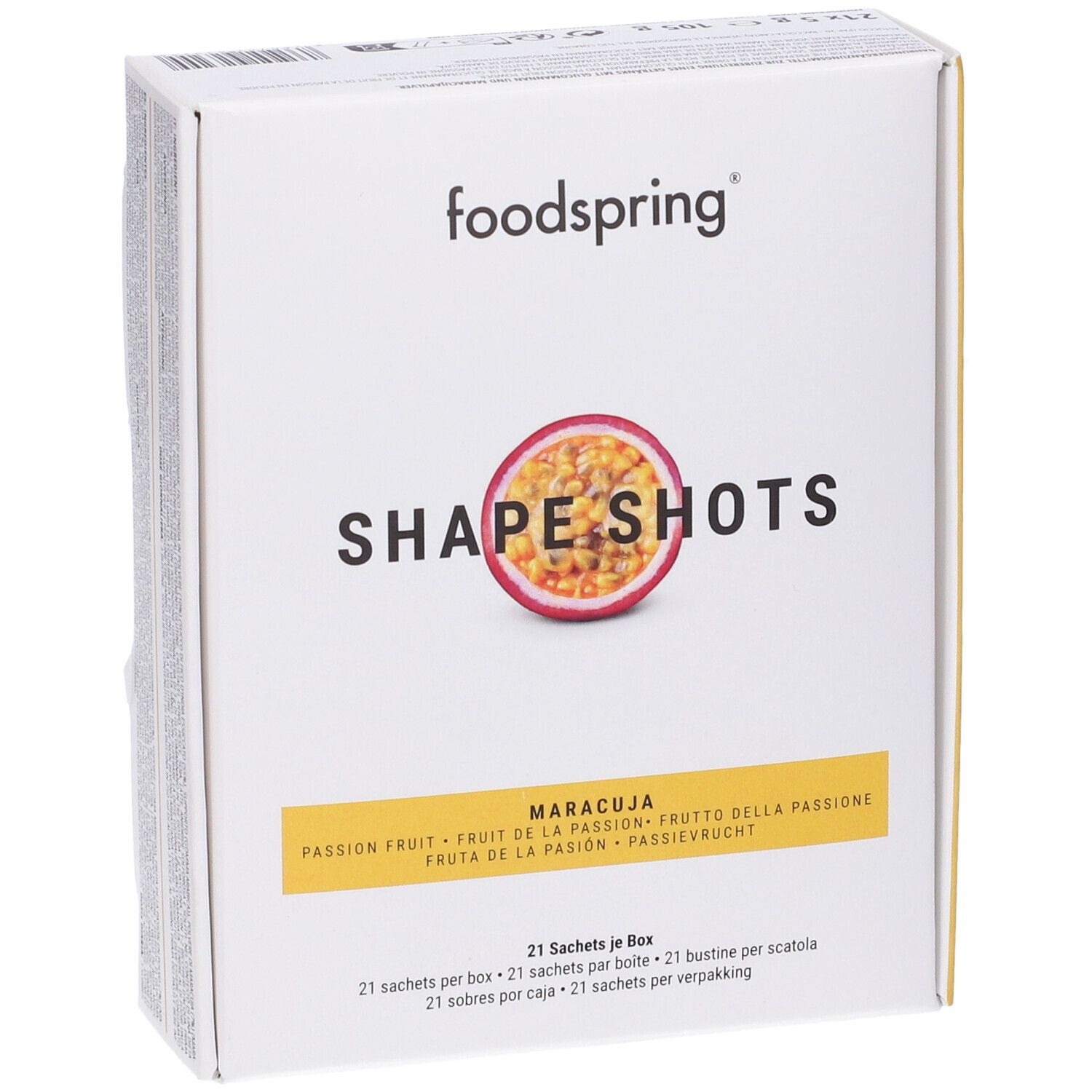 Scatola bianca con logo Foodspring e nome del prodotto. Immagine di frutto della passione. Testo: Shape Shots, Maracuja, 21 bustine per scatola.