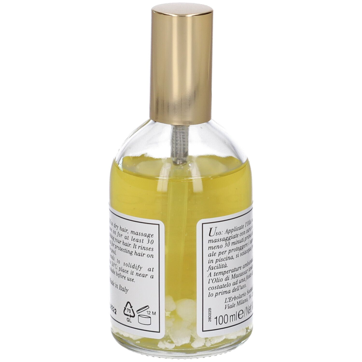 Glasflasche mit goldenem Verschluss, gefüllt mit gelbem Haaröl und kleinen weißen Partikeln.