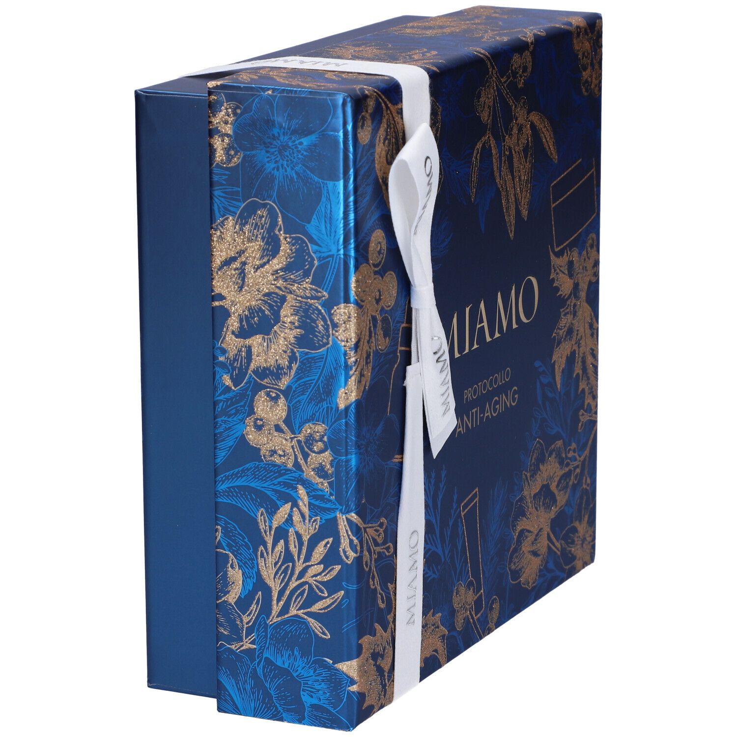 Confezione regalo blu con motivi floreali dorati e nastro bianco. Scritta: Miamo. Vista laterale.