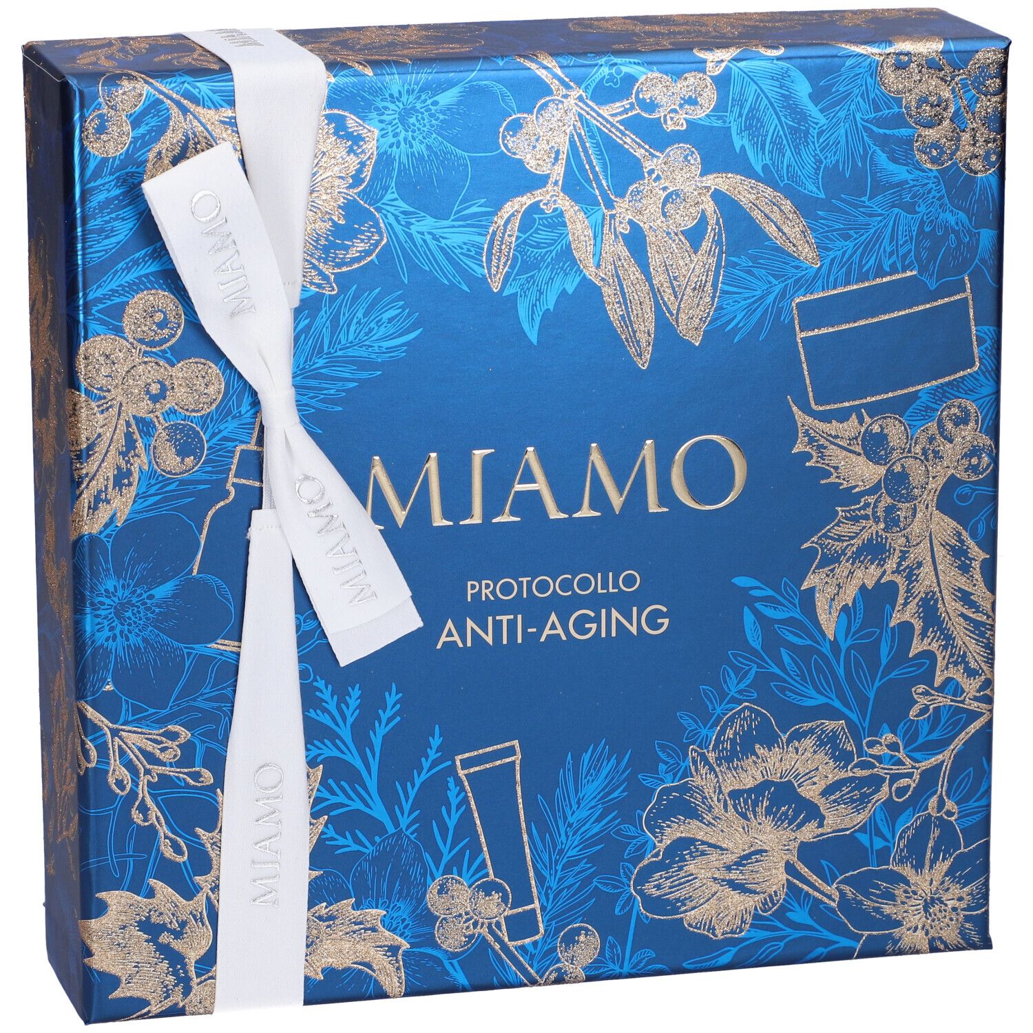 Confezione regalo blu con motivi floreali dorati e nastro bianco. Scritta: Miamo, Protocollo Anti-Aging. Vista dall'alto.