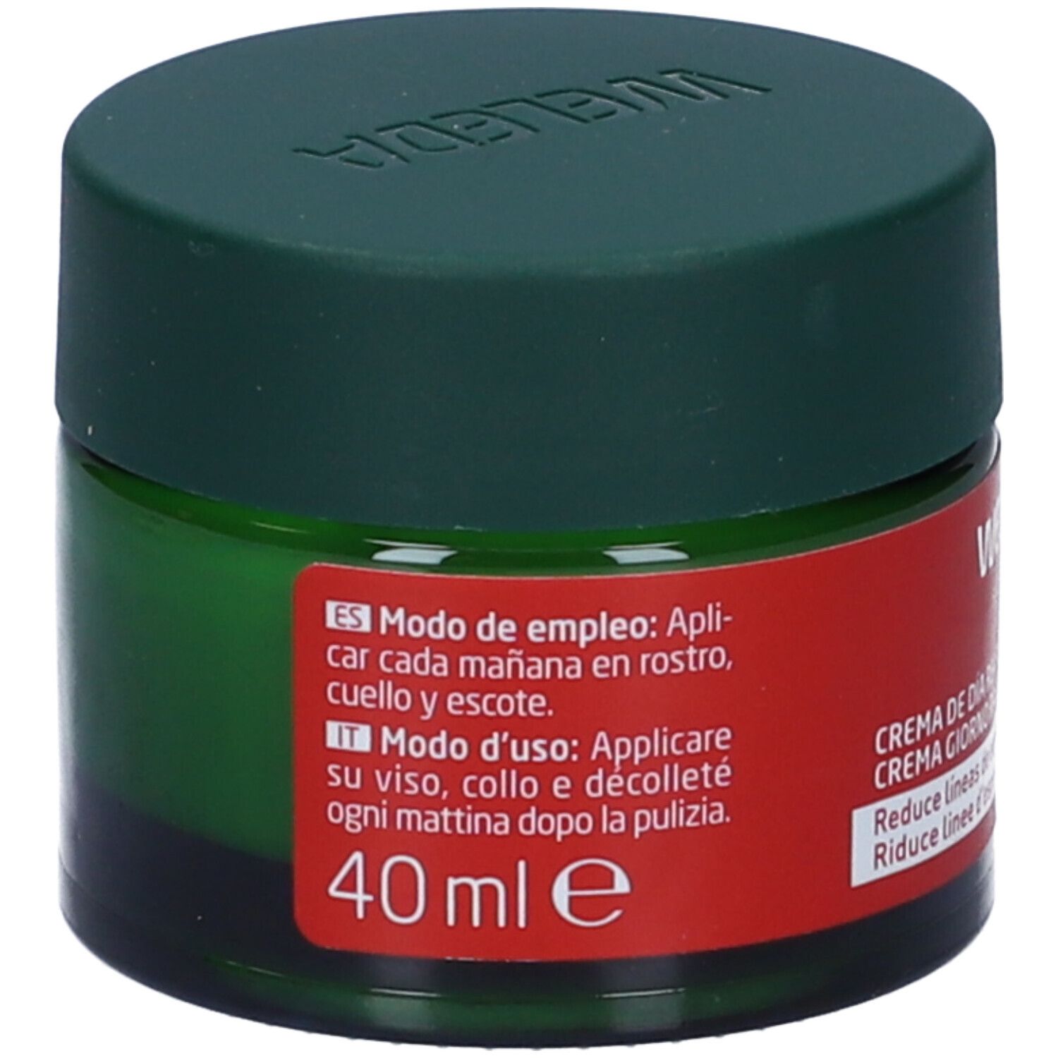 Vaso verde con coperchio. Etichetta rossa con nome del prodotto, istruzioni in spagnolo e italiano. Marca Weleda.