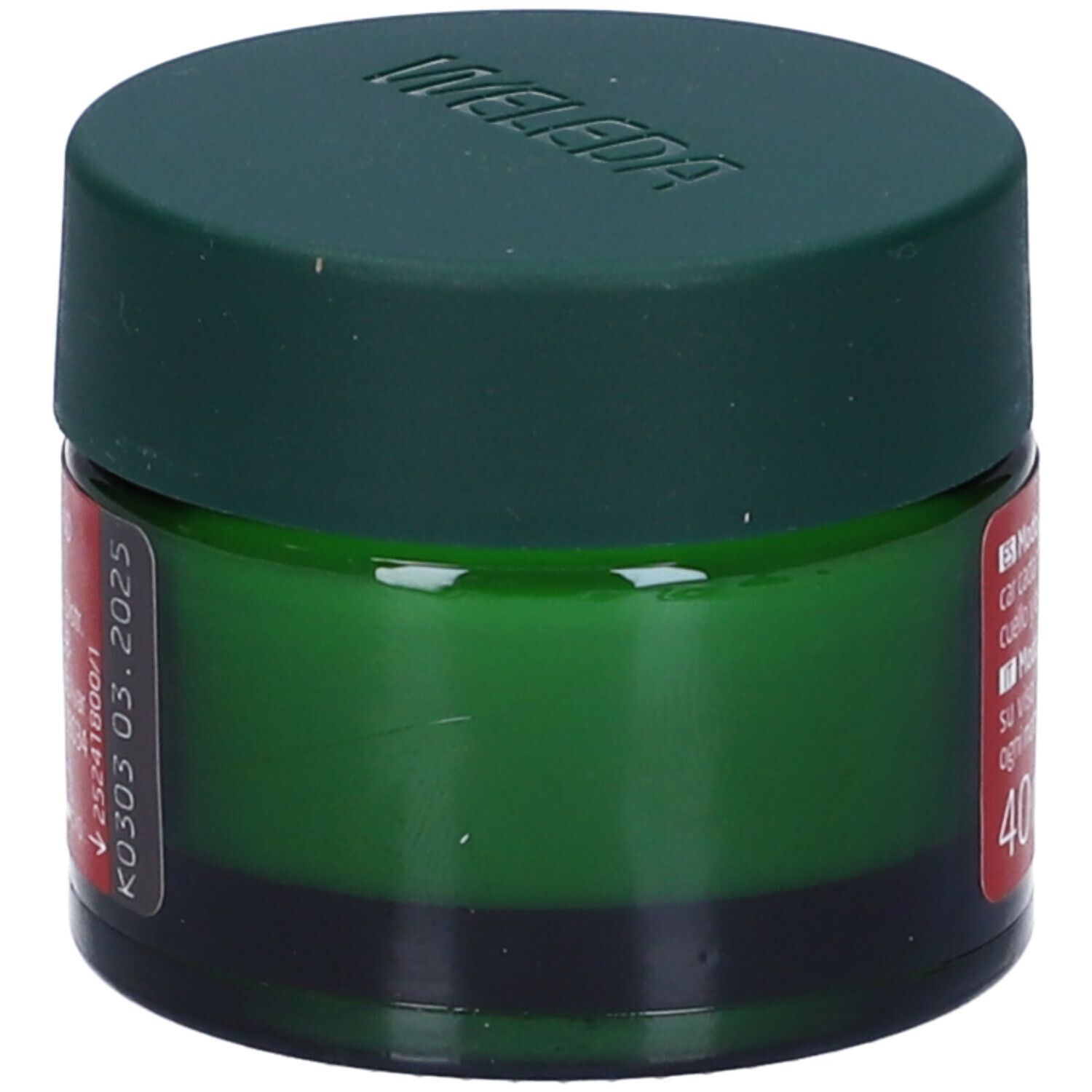 Vaso verde con coperchio. Etichetta rossa con informazioni sul prodotto e data di scadenza. Marca Weleda. 40 ml.