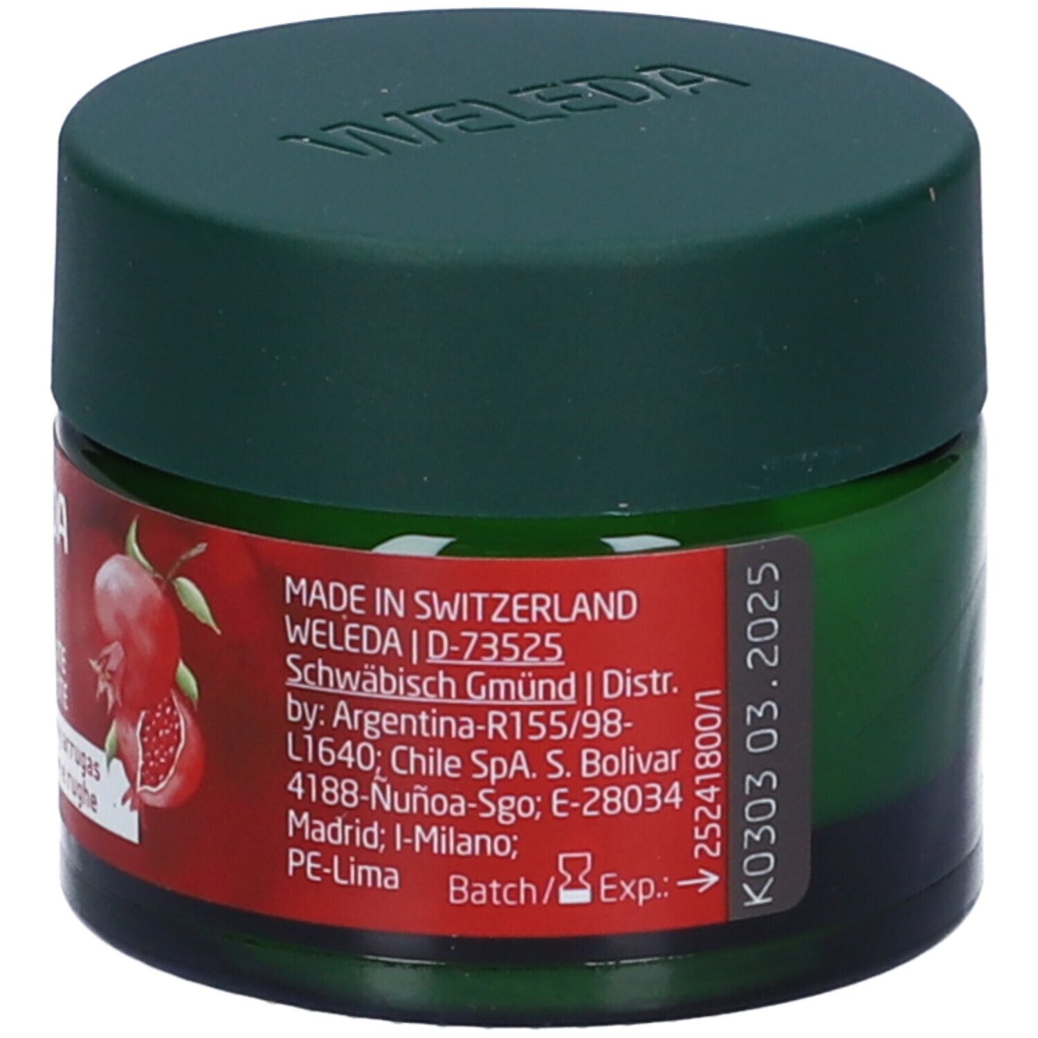 Vaso verde con coperchio. Etichetta rossa con informazioni sul prodotto, origine Svizzera e data di scadenza. Marca Weleda.