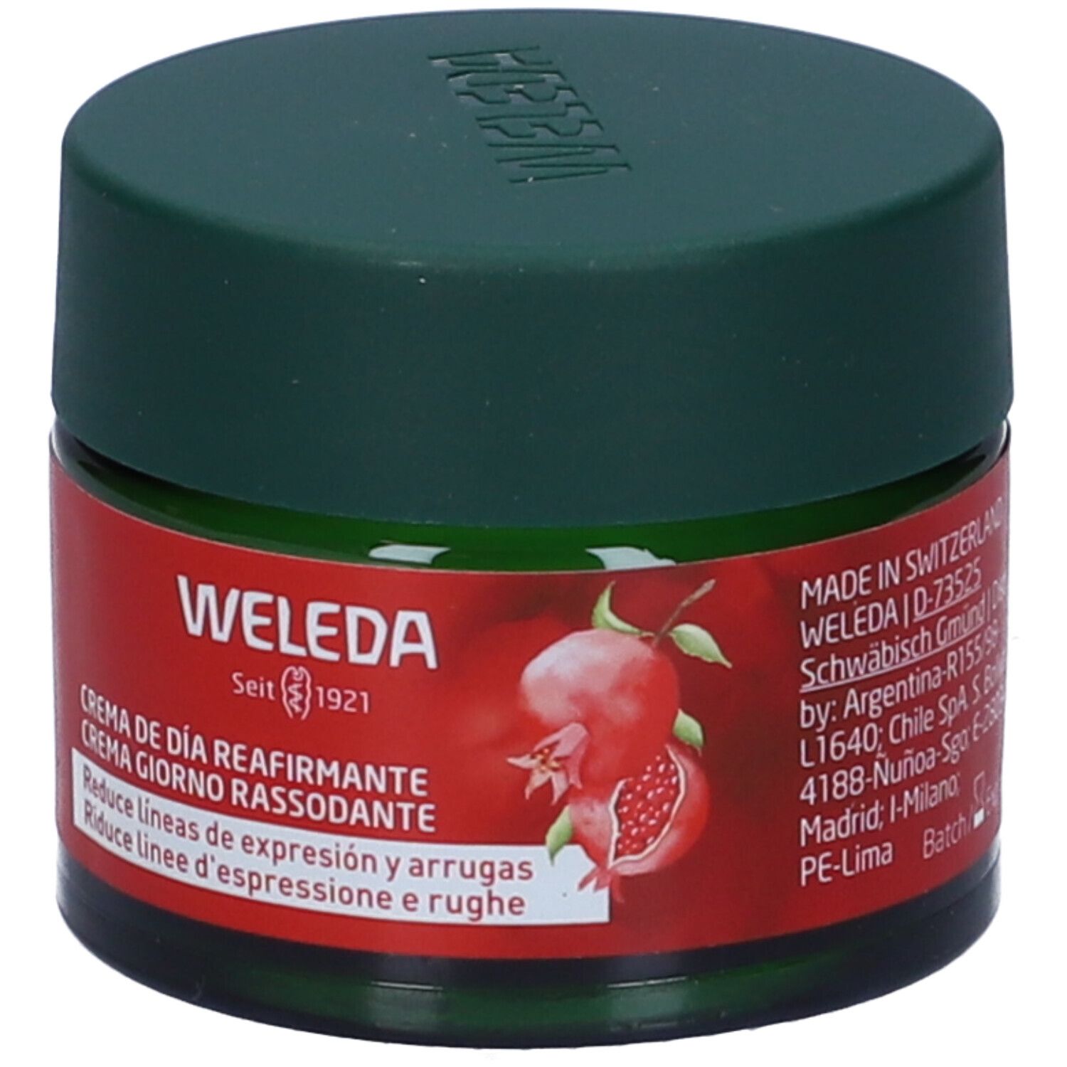 Vaso verde con coperchio. Etichetta rossa con nome del prodotto e illustrazione di melograno. Marca Weleda, dal 1921.