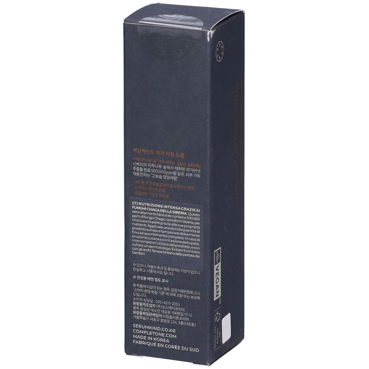 Confezione del prodotto grigio scuro con testo multilingue. Logo vegano e altri marchi visibili.