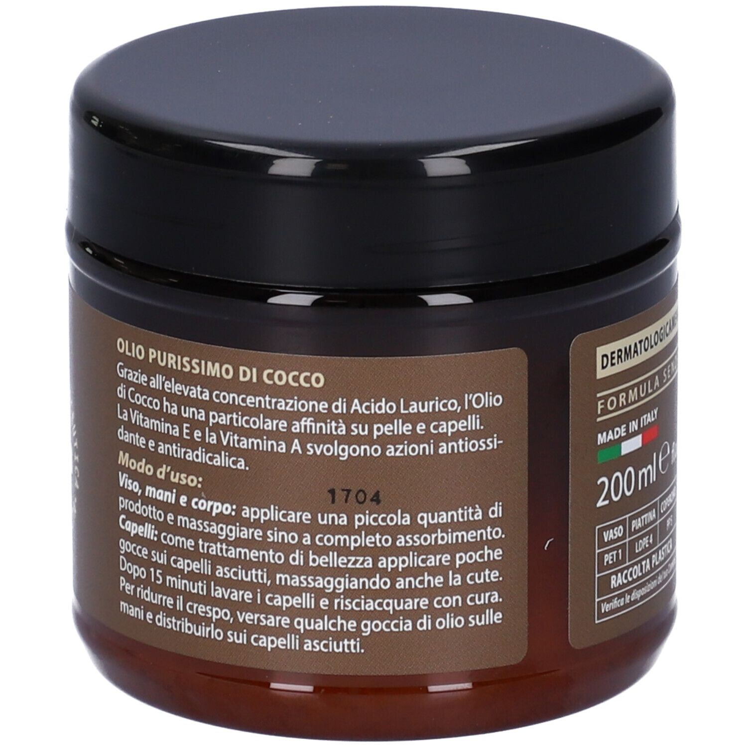 Retro di un barattolo marrone con coperchio nero. Testo: Olio Purissimo di Cocco. Istruzioni per viso, mani e capelli.