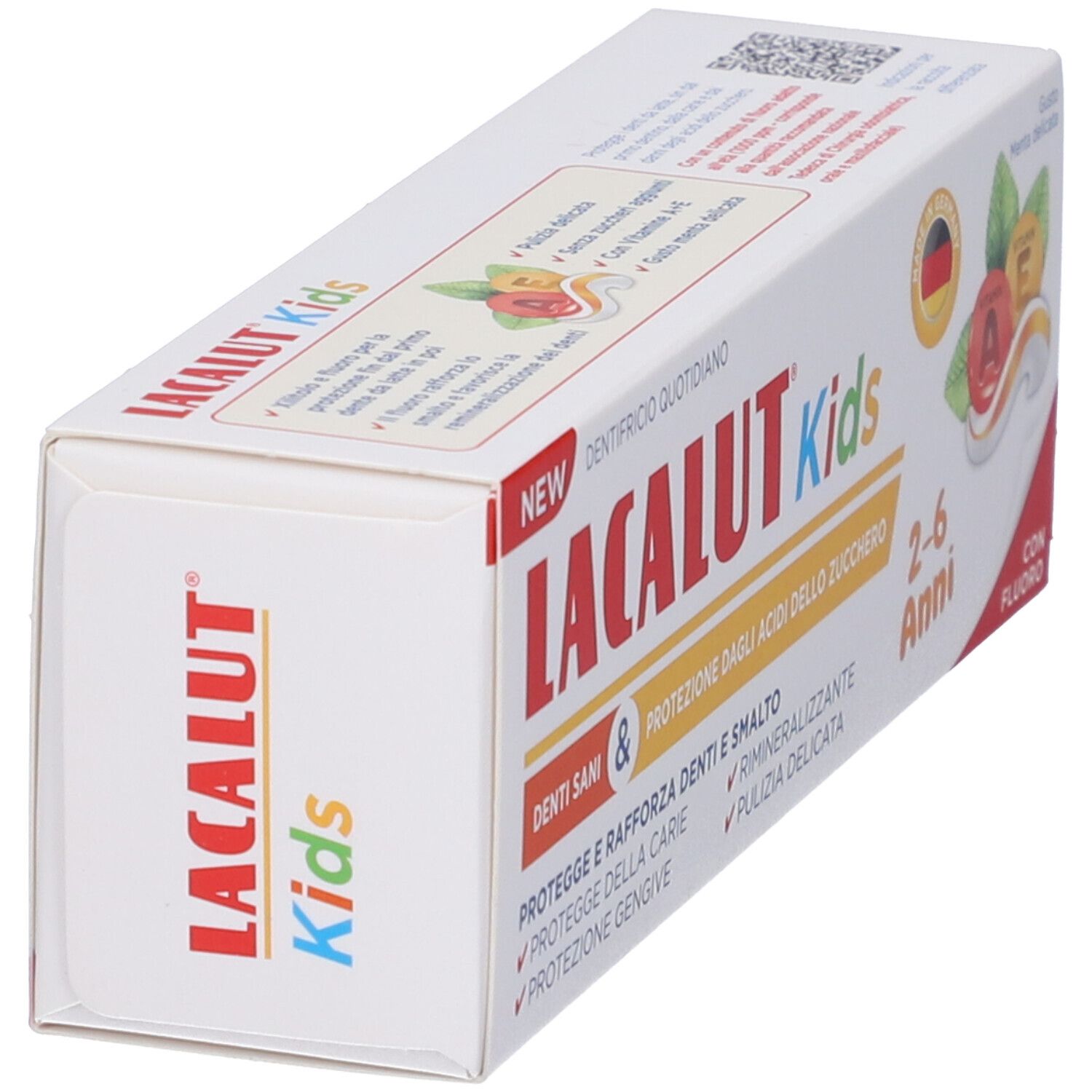 Confezione di dentifricio. Scritta LACALUT Kids, 2-6 Anni, con fluoro. Contiene vitamine A ed E. Bandiera tedesca.