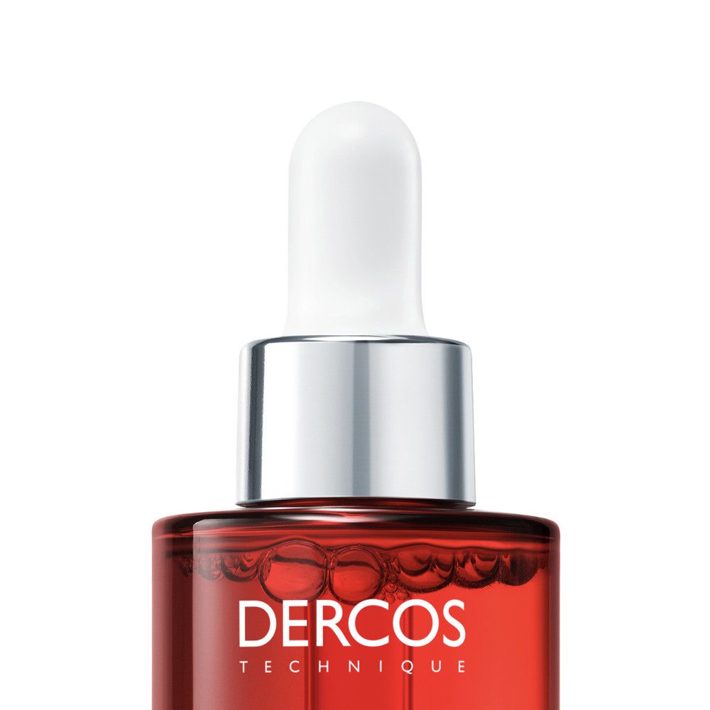 Rote Glasflasche mit silbernem Applikator und weißem Tropfer. Dercos Technique Schriftzug.