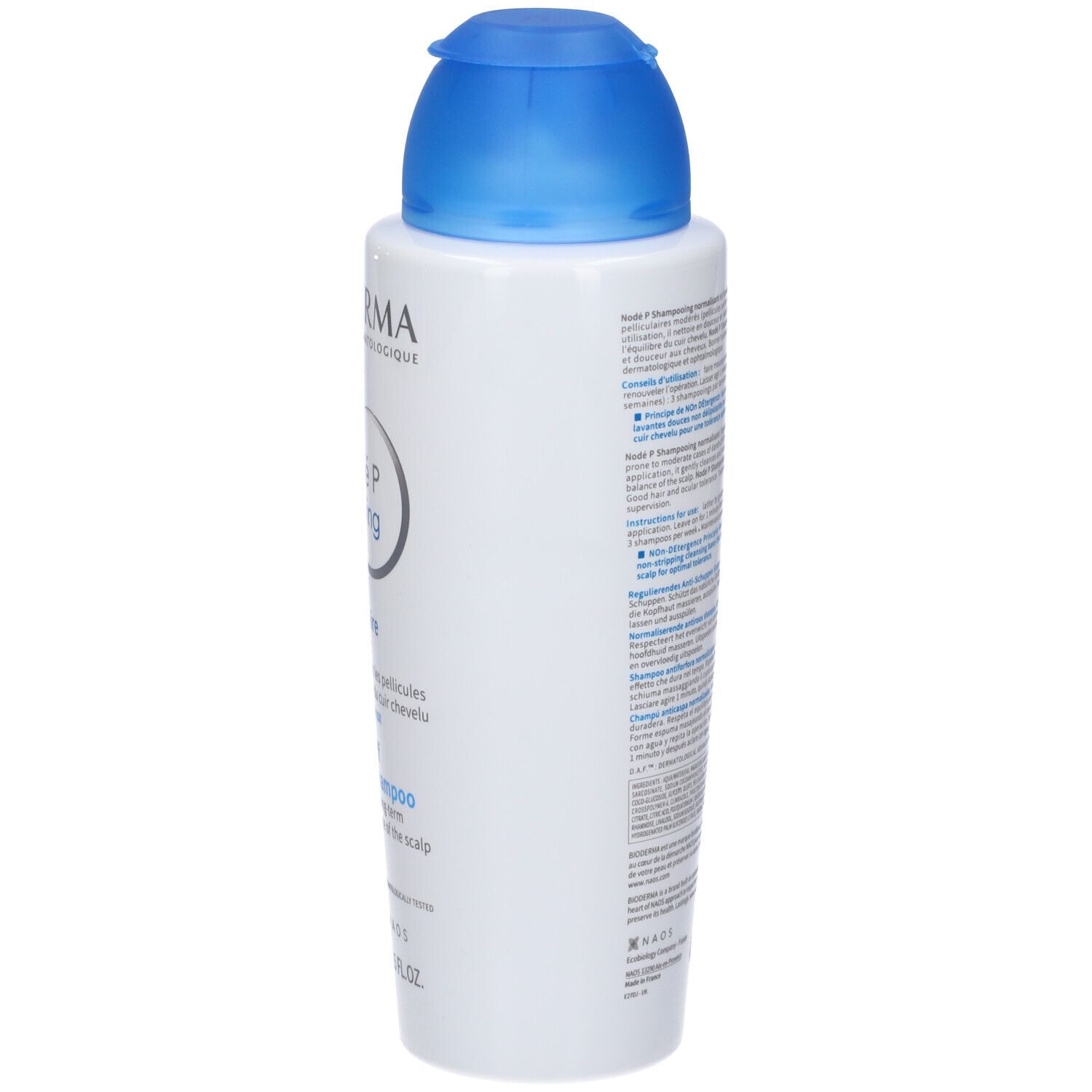 Flacone bianco, tappo blu. Lato con testo. Bioderma Nodé P Shampooing. Informazioni e volume.