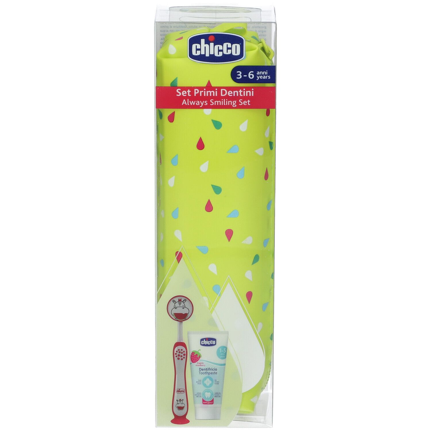 Chicco Set Primi Dentini. Astuccio verde-giallo, spazzolino, dentifricio e specchietto orale in confezione trasparente. Testo sulla confezione.