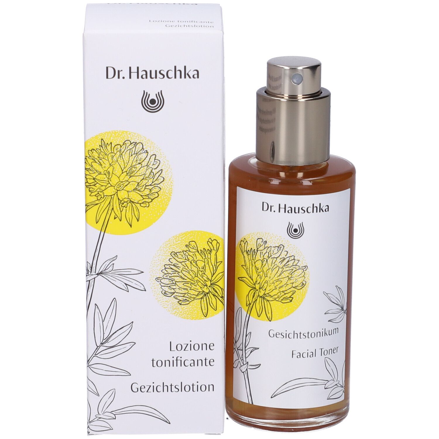 Flacone di vetro marrone con vaporizzatore e scatola. Etichetta con nome del prodotto e design floreale. Dr. Hauschka Facial Toner.