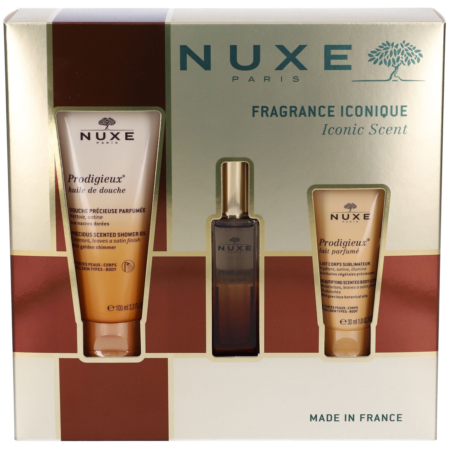 Confezione regalo con tre prodotti. Due tubi e una bottiglia. Scritta: Nuxe Paris, Fragrance Iconique. Prodotti visibili.