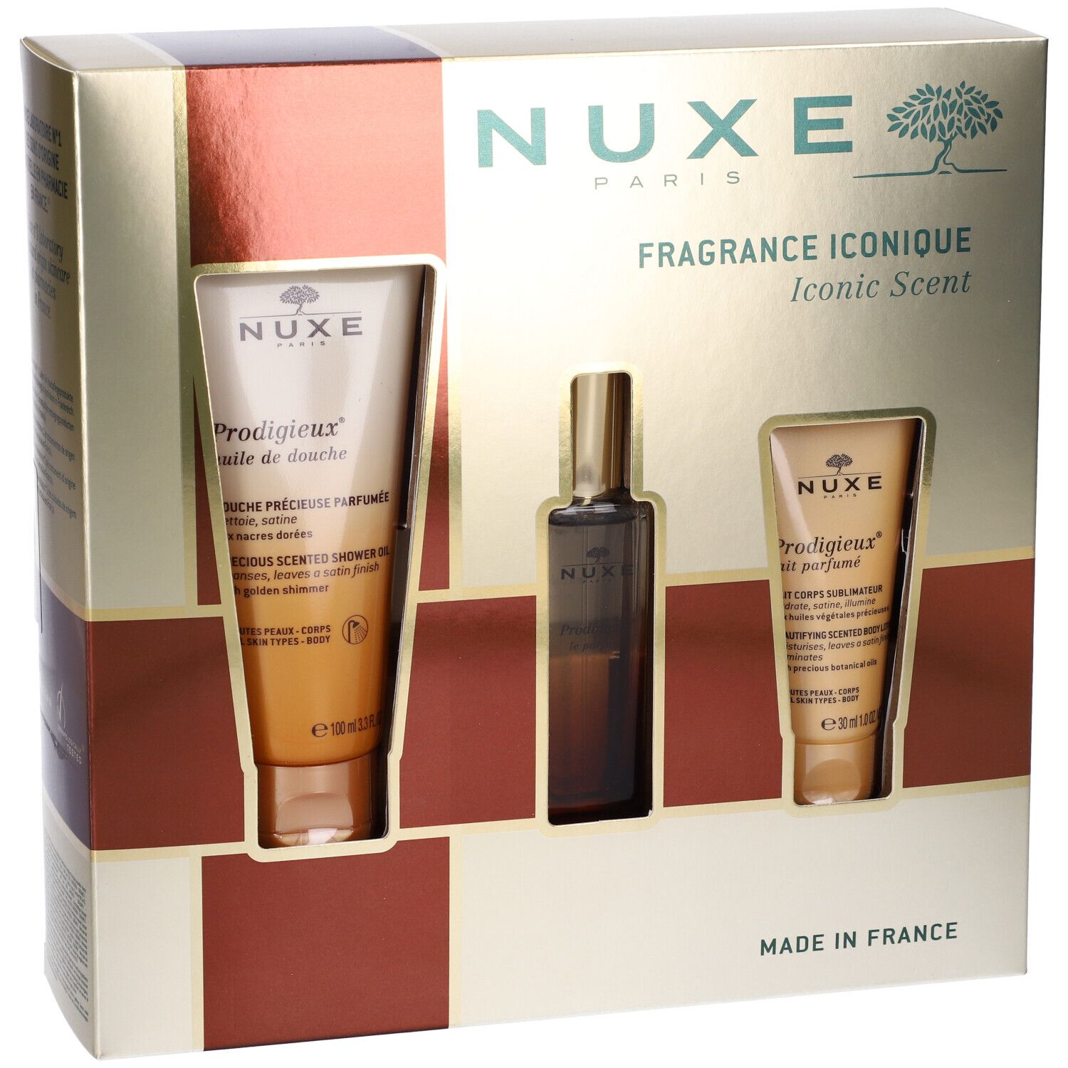 Confezione regalo con tre prodotti. Due tubi e una bottiglia. Scritta: Nuxe Paris, Fragrance Iconique. Prodotti visibili.