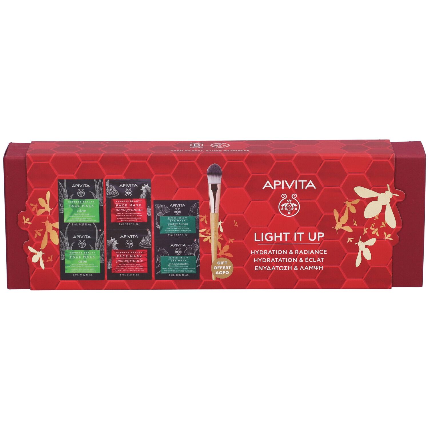 Confezione regalo rossa con maschere viso e pennello applicatore. Scritta: Apivita, Light it up.
