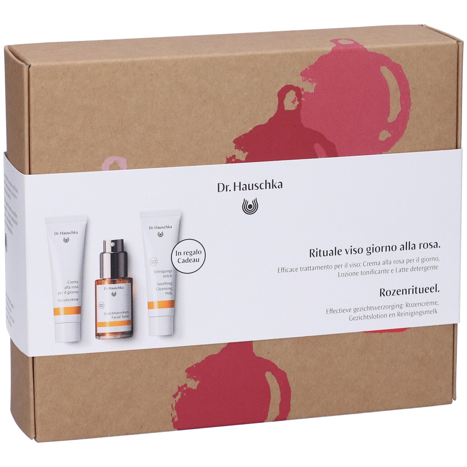 Set regalo con tre prodotti. Scritta: Dr. Hauschka. Rituale alla rosa. Creme e lozioni confezionate in scatola.