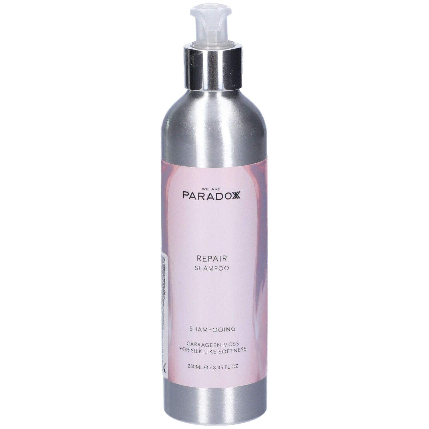 Flacone shampoo argento con dosatore. Etichetta "We Are Paradox Repair Shampoo".