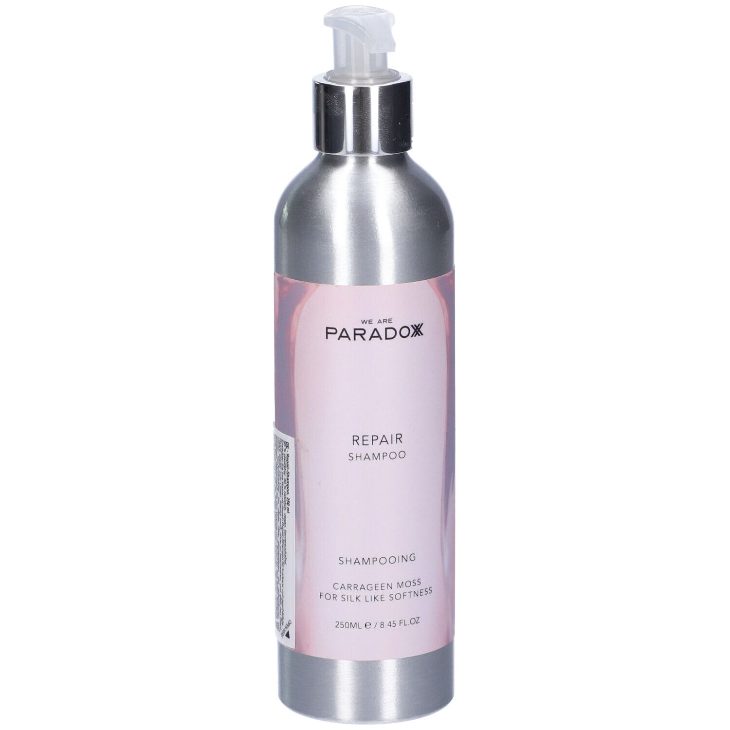 Flacone shampoo argento con dosatore. Etichetta "We Are Paradox Repair Shampoo".