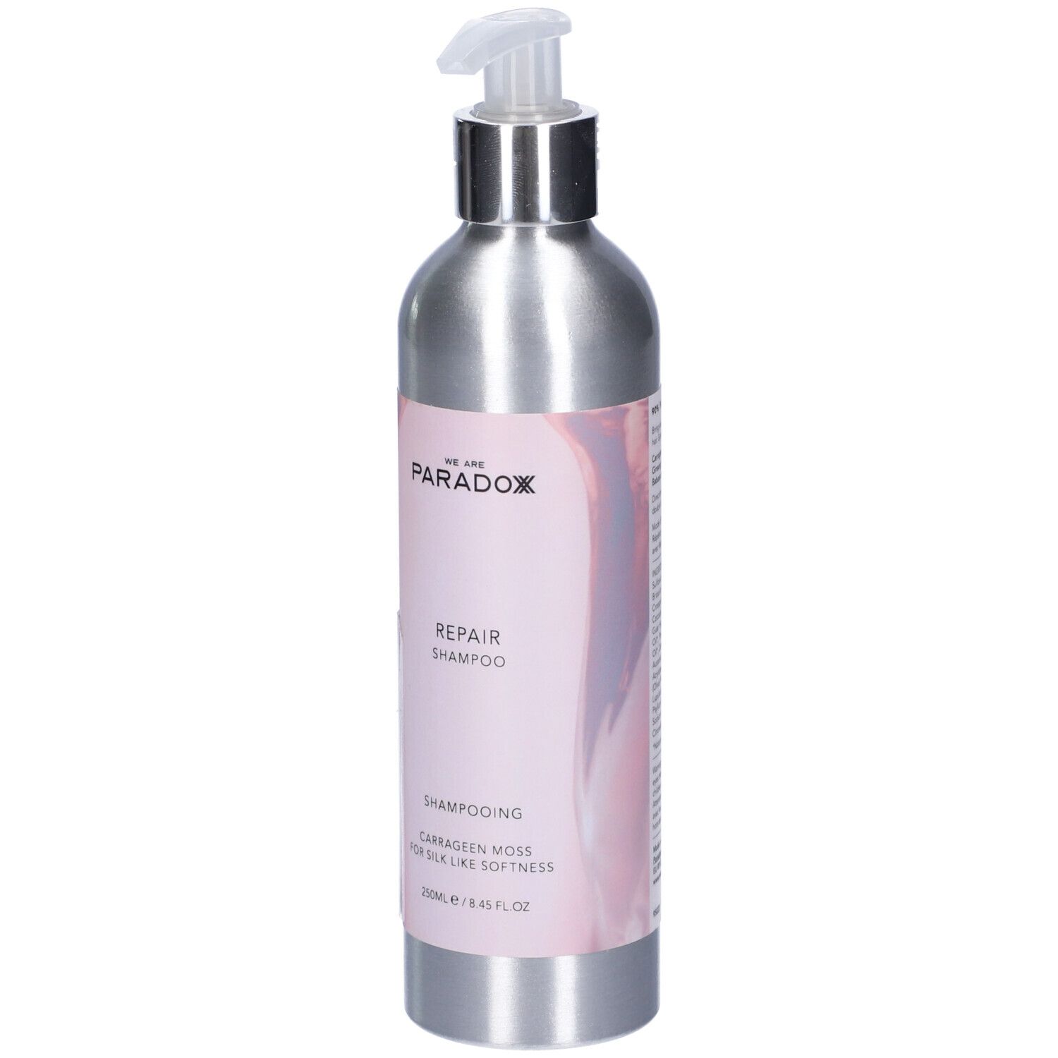 Flacone shampoo argento con dosatore. Etichetta "We Are Paradox Repair Shampoo".