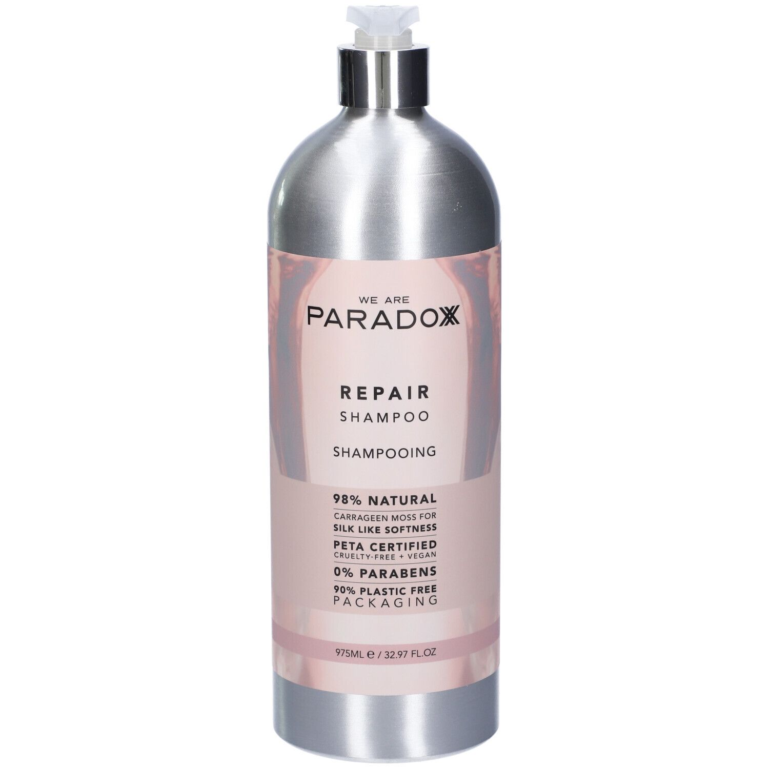 Flacone di shampoo argento con etichetta rosa. Scritta: WE ARE PARADOX REPAIR SHAMPOO. Certificazione PETA. 975ml.
