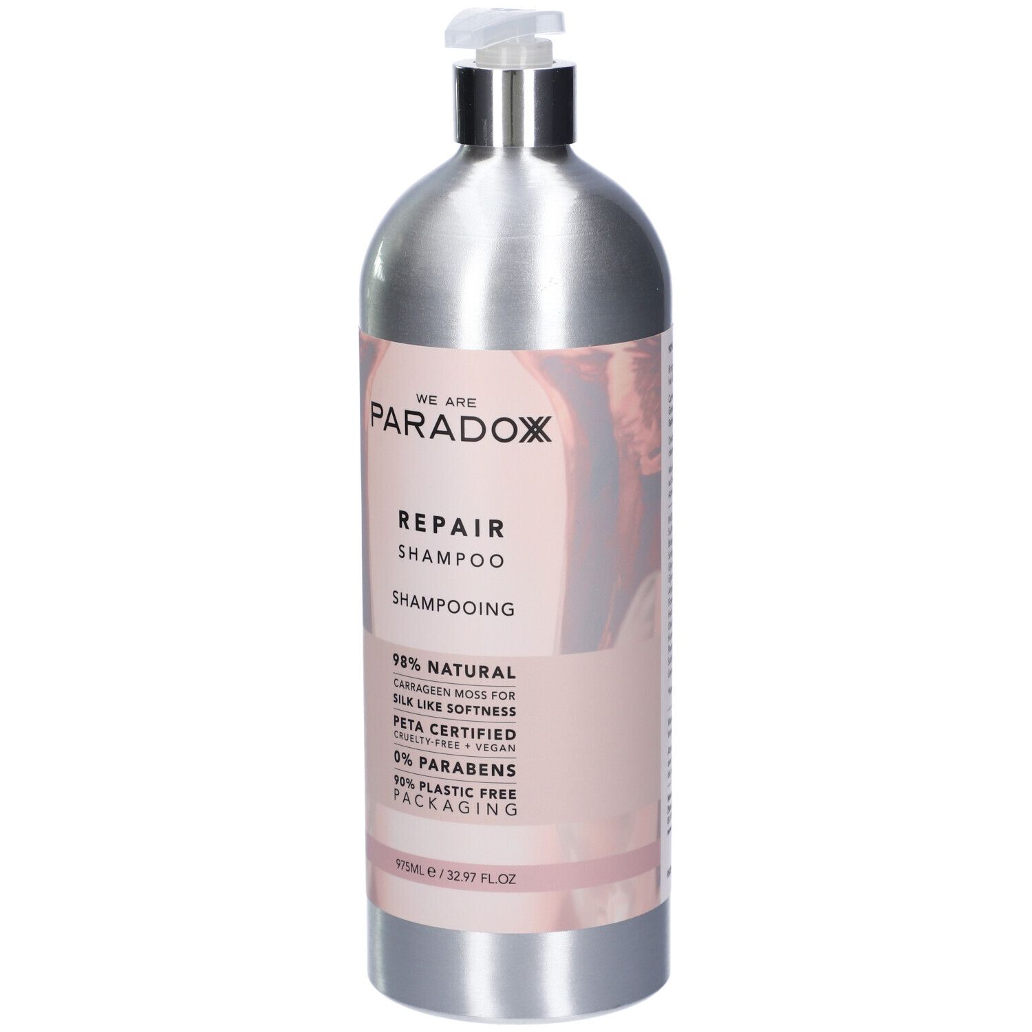 Flacone di shampoo argento con etichetta rosa. Scritta: WE ARE PARADOX REPAIR SHAMPOO. Certificazione PETA. 975ml.