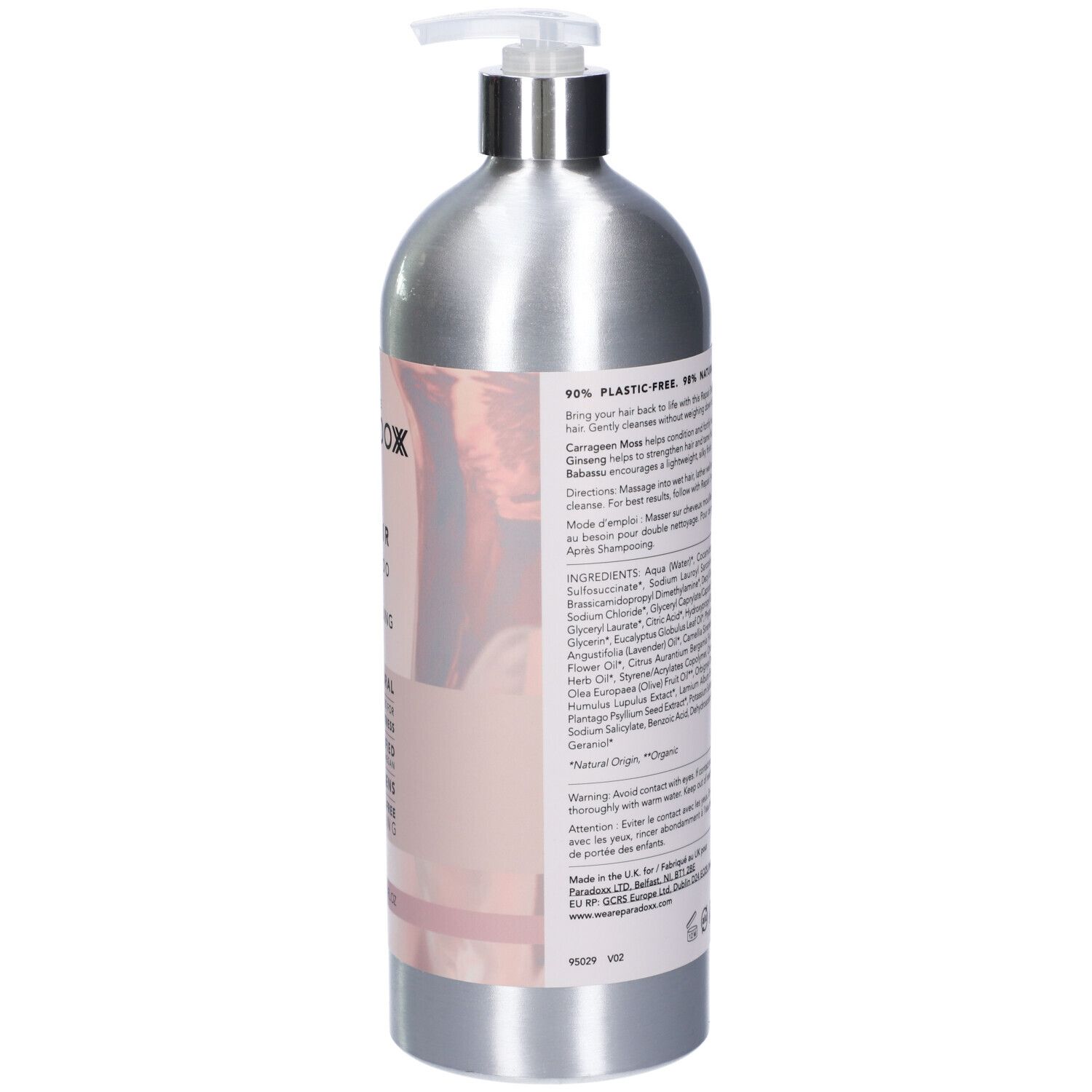 Retro del flacone di shampoo argento. Etichetta rosa con ingredienti, istruzioni e certificazioni. Testo multilingue.