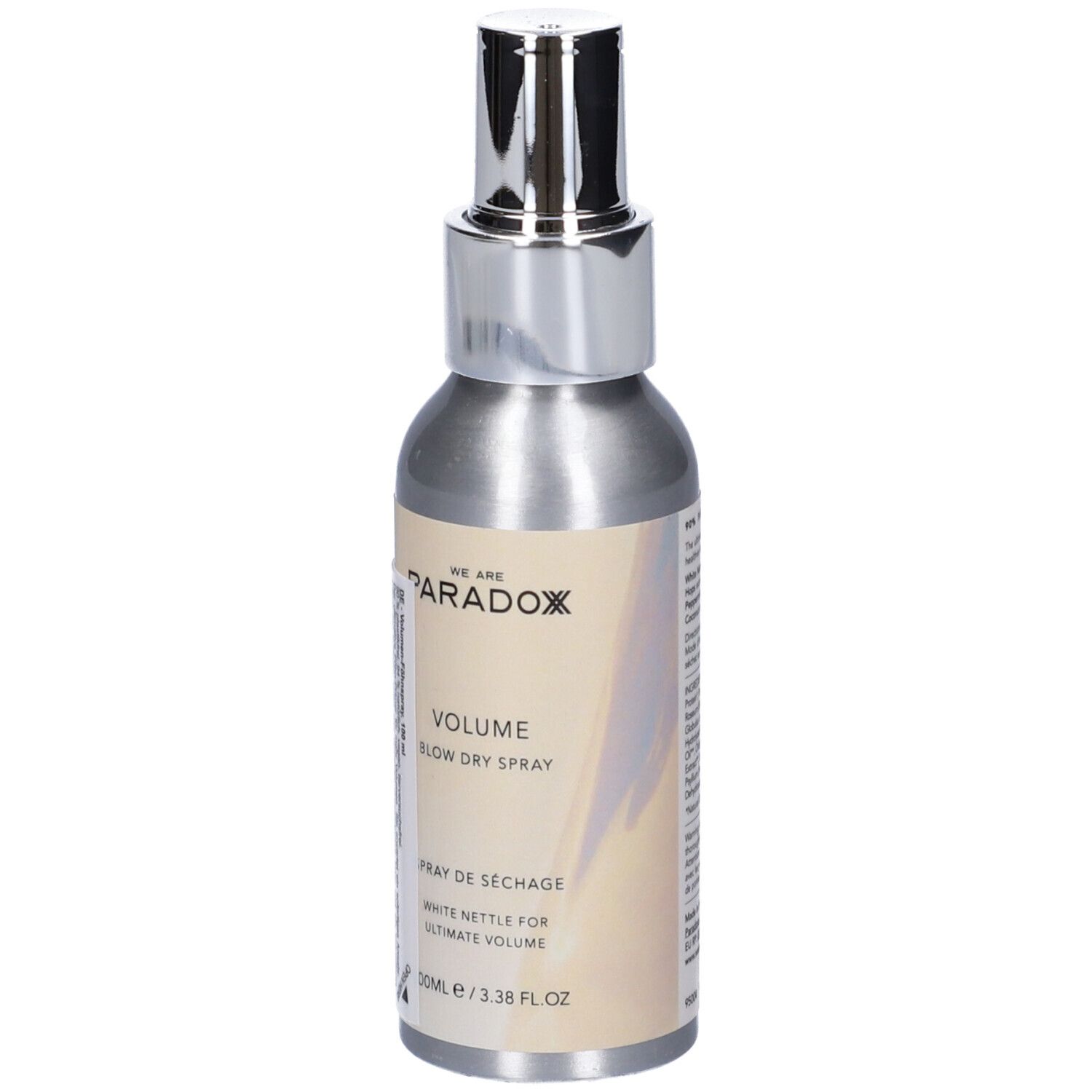 Flacone spray argento con erogatore argento. Scritta: WE ARE PARADOX, VOLUME, BLOW DRY SPRAY, Spray de séchage. 100ml/3.38 FL OZ.