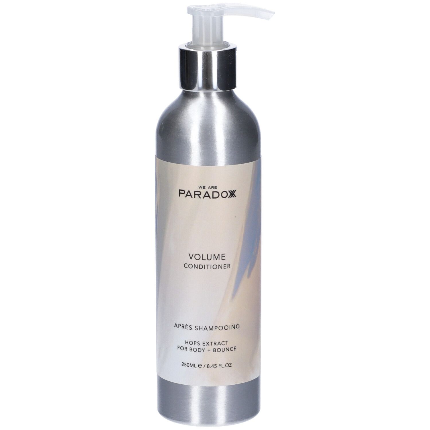 Flacone argento con dosatore. Etichetta con nome prodotto e ingredienti. "We Are Paradox Volume Conditioner".