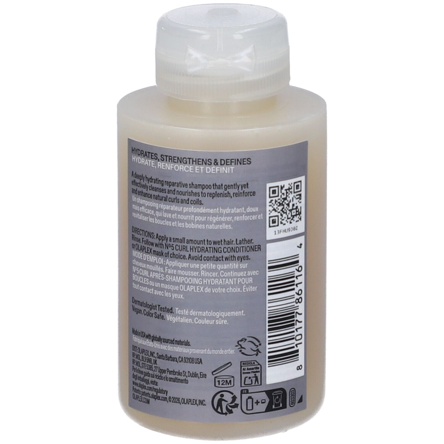 Piccola bottiglia di shampoo marrone chiaro con tappo bianco. Contiene testo e codice a barre.