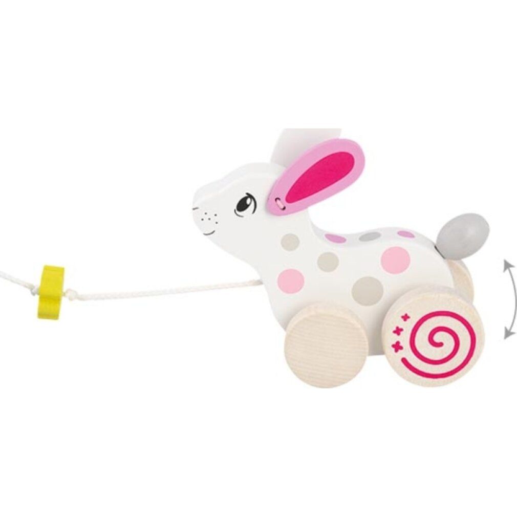 Holzspielzeug Hase mit Rädern und Schnur. Weiß mit rosa und grauen Punkten. Kleeblatt am Seil. Räder mit Spiralmuster.