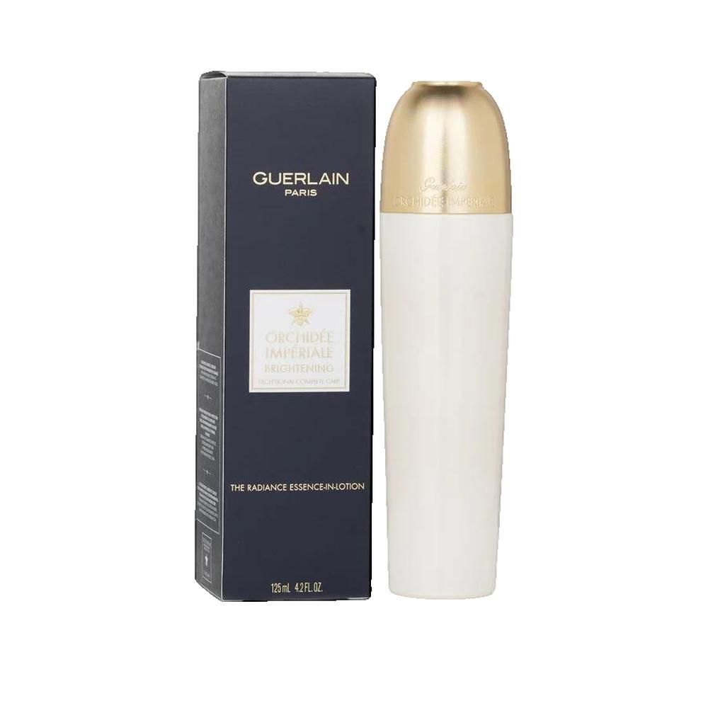 Weißes Fläschchen mit goldfarbenem Deckel neben einer schwarzen Schachtel. Auf der Schachtel steht "GUERLAIN PARIS".