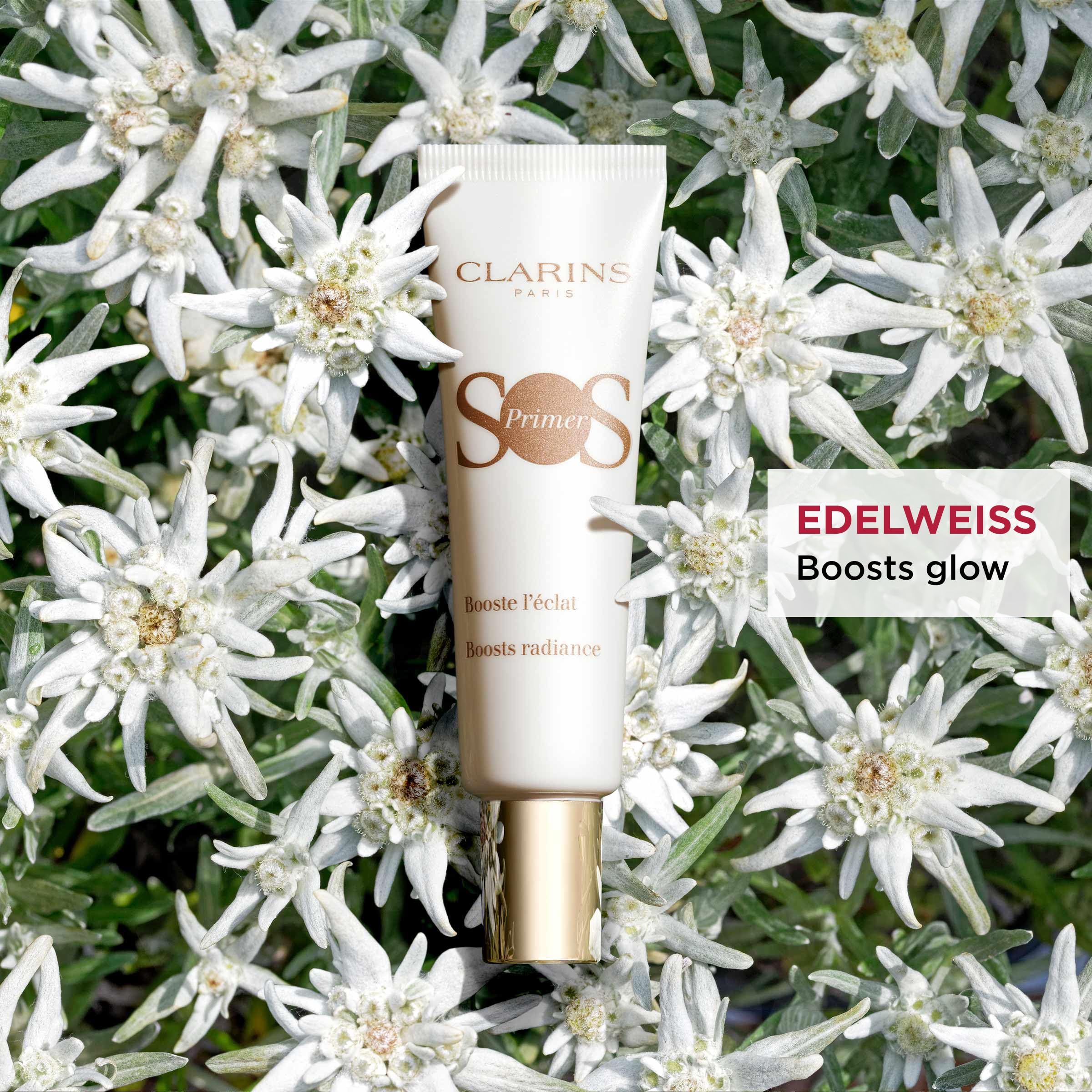 Weiße Tube mit Text. Umgeben von weißen Blüten. Text: SOS Primer.