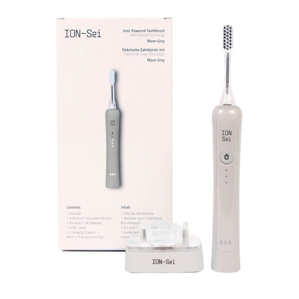 ION-Sei Moon Grey Zahnbürste mit Verpackung. Graue Zahnbürste, Ladestation. Produktname und Beschreibung auf der Verpackung.
