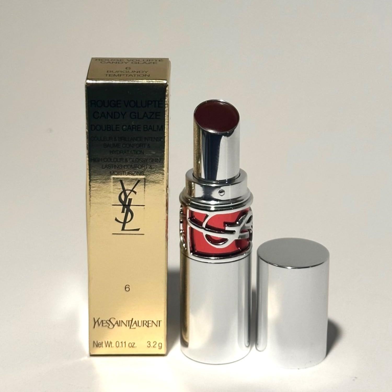 YSL Rossetto #6, geöffnet, mit Verpackung. Silberner Stift, goldene Verpackung mit Logo und Produktbezeichnung.