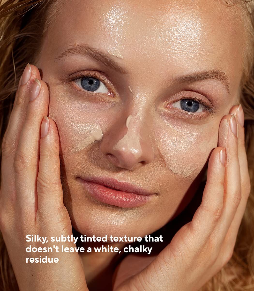 Frau mit Sonnencreme im Gesicht. Text: Seidige, leicht getönte Textur, die keinen weißen, kreidigen Rückstand hinterlässt.